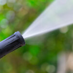Close,Up,Of,High,Pressure,Water,Nozzle,On,Green,Nature