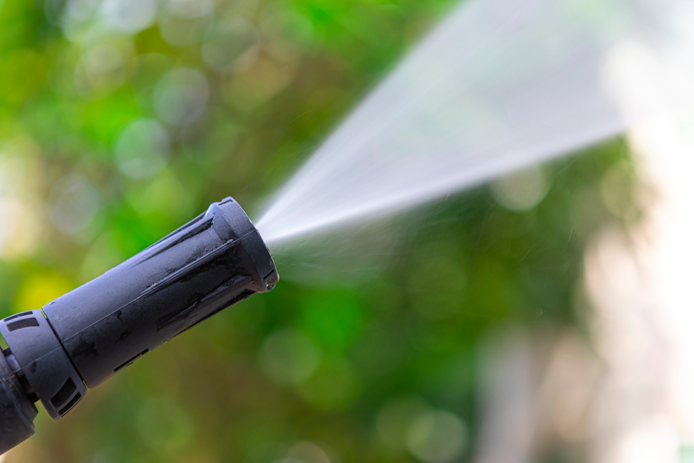 Close,Up,Of,High,Pressure,Water,Nozzle,On,Green,Nature